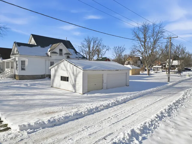 a front view of a house with a snow in front of it