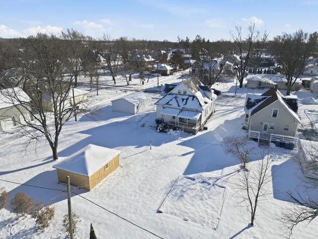 an aerial view of a house with yard and mountain view in back