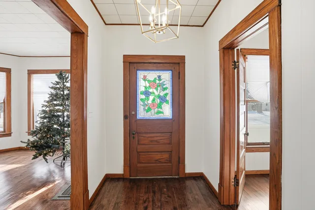 hallway with wooden floor and front door