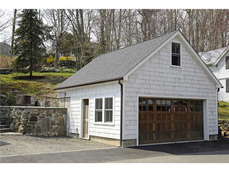 226 Valley Road Cos Cob, CT 06807 - Photo 16 of 17 a front view of a house with a yard