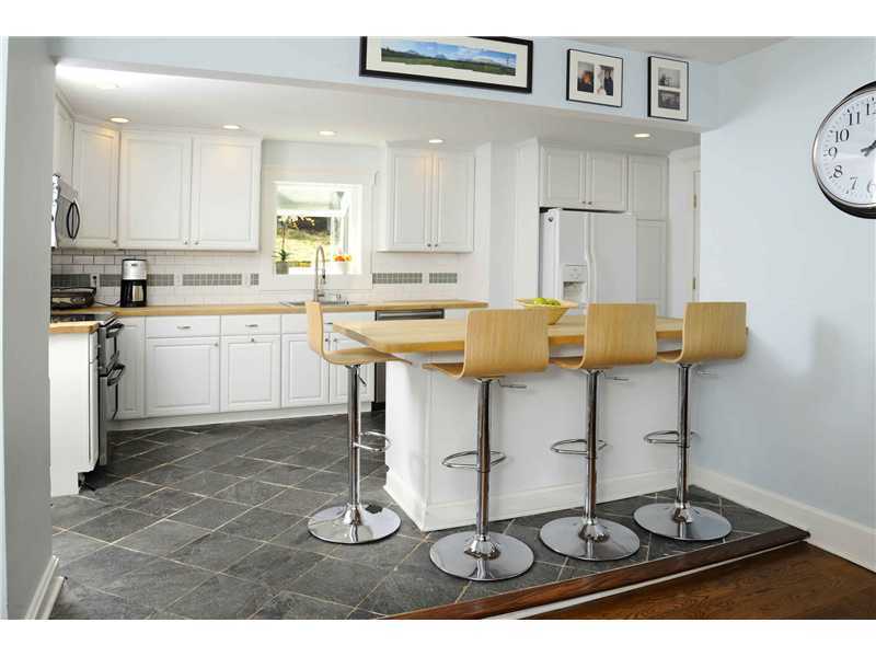 226 Valley Road Cos Cob, CT 06807 - Photo 7 of 17 a kitchen with stainless steel appliances granite countertop a stove and white cabinets