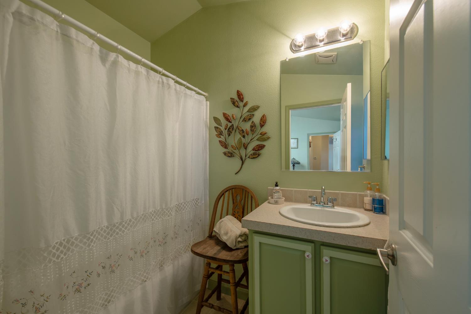 33751 Powerhouse Road, Unit 21 Auberry, CA 93602 - Photo 15 of 29 a bathroom with a sink and a mirror