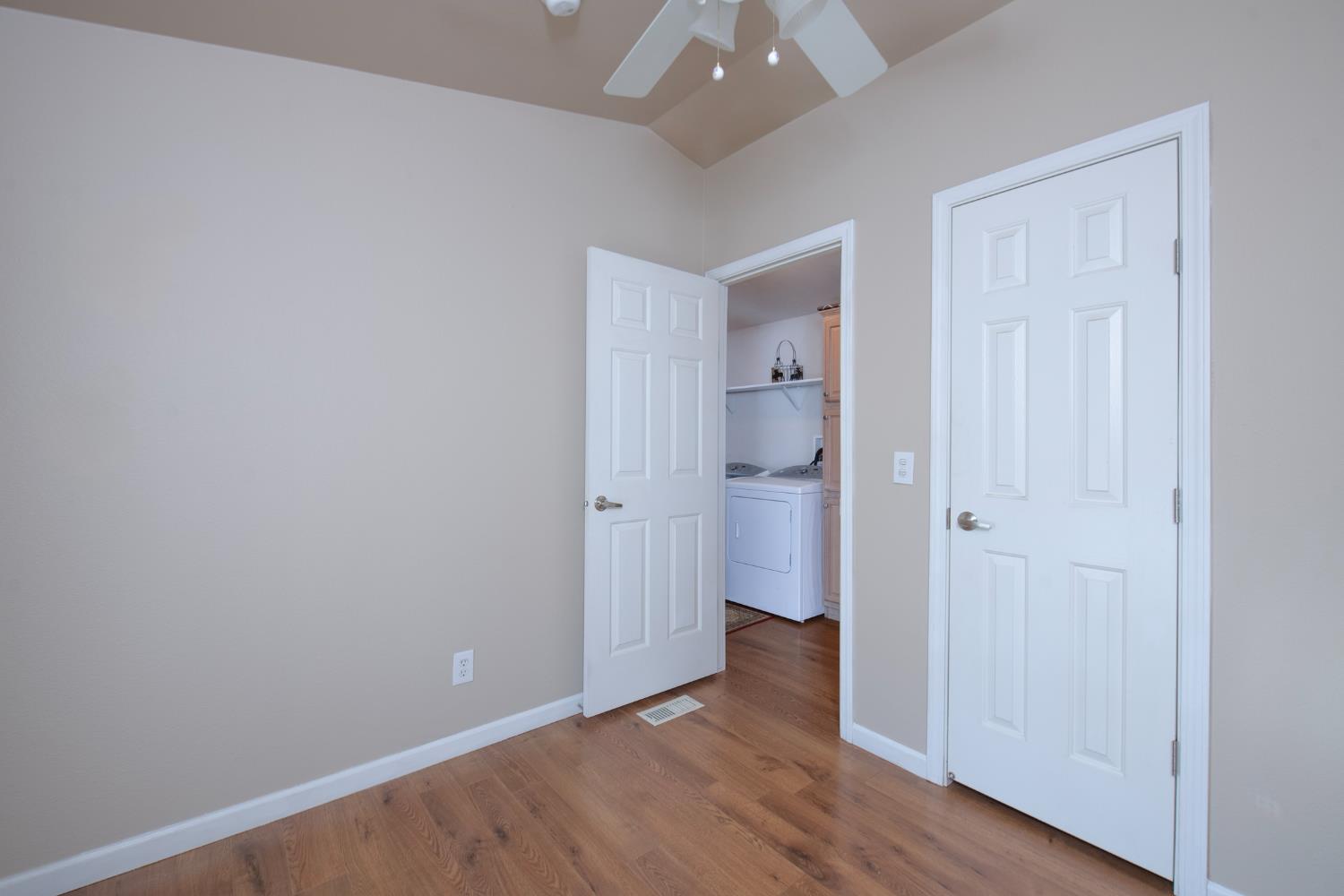 33751 Powerhouse Road, Unit 21 Auberry, CA 93602 - Photo 16 of 29 a view of an empty room with wooden floor and a bathroom