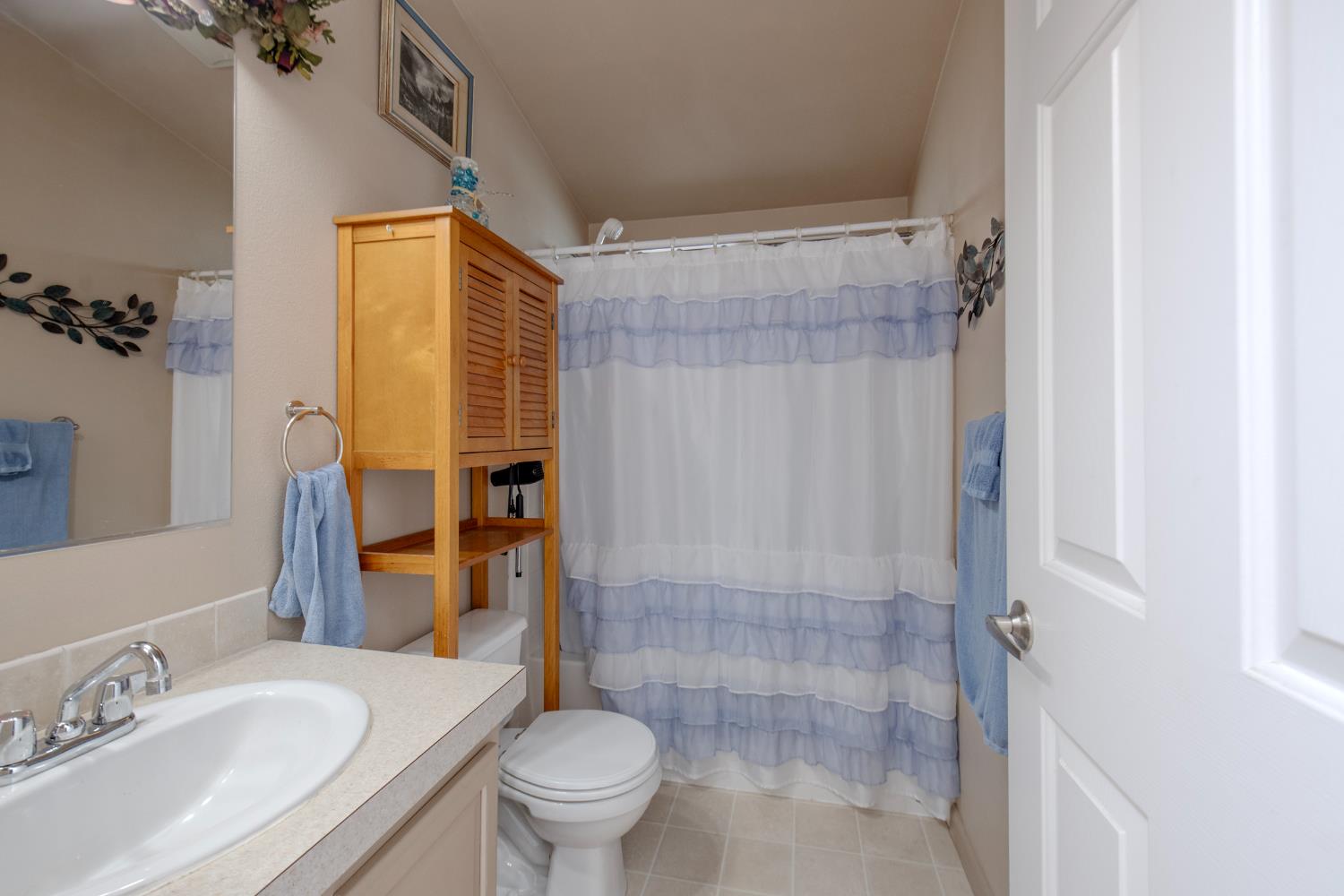 33751 Powerhouse Road, Unit 21 Auberry, CA 93602 - Photo 18 of 29 a bathroom with a granite countertop sink toilet and shower