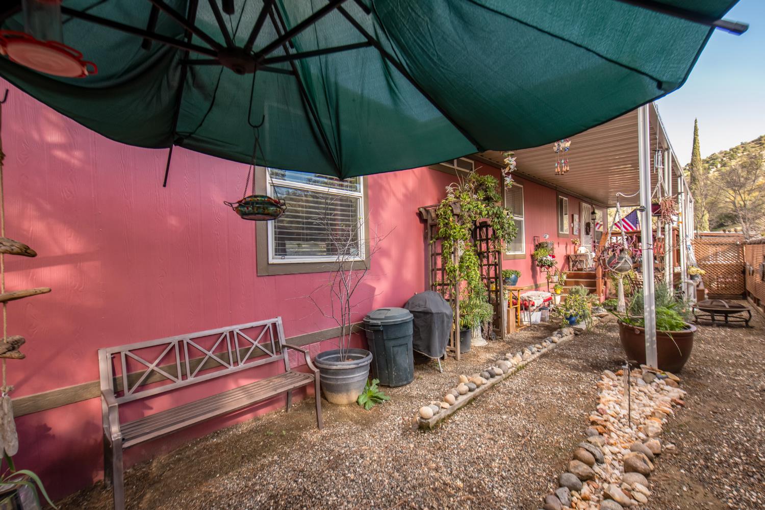 33751 Powerhouse Road, Unit 21 Auberry, CA 93602 - Photo 22 of 29 a view of a patio with table and chairs under an umbrella