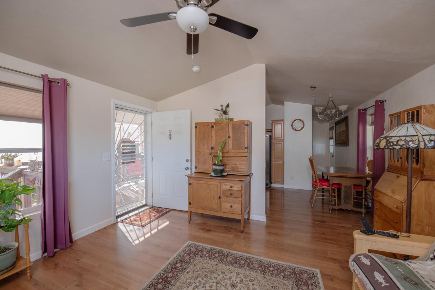 33751 Powerhouse Road, Unit 21 Auberry, CA 93602 - Photo 4 of 29 a living room with furniture and a flat screen tv