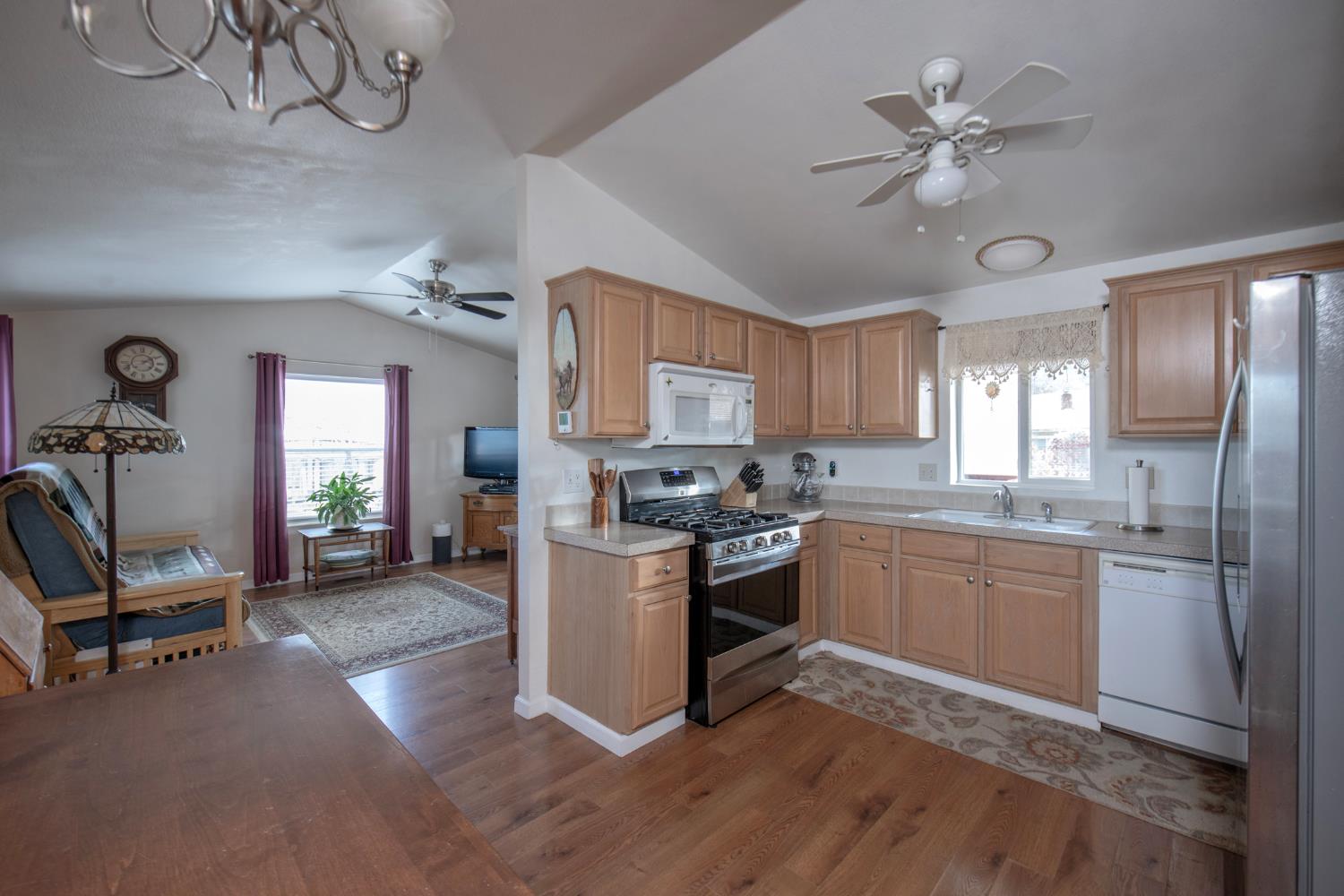 33751 Powerhouse Road, Unit 21 Auberry, CA 93602 - Photo 7 of 29 a kitchen with stainless steel appliances granite countertop a stove refrigerator and cabinets