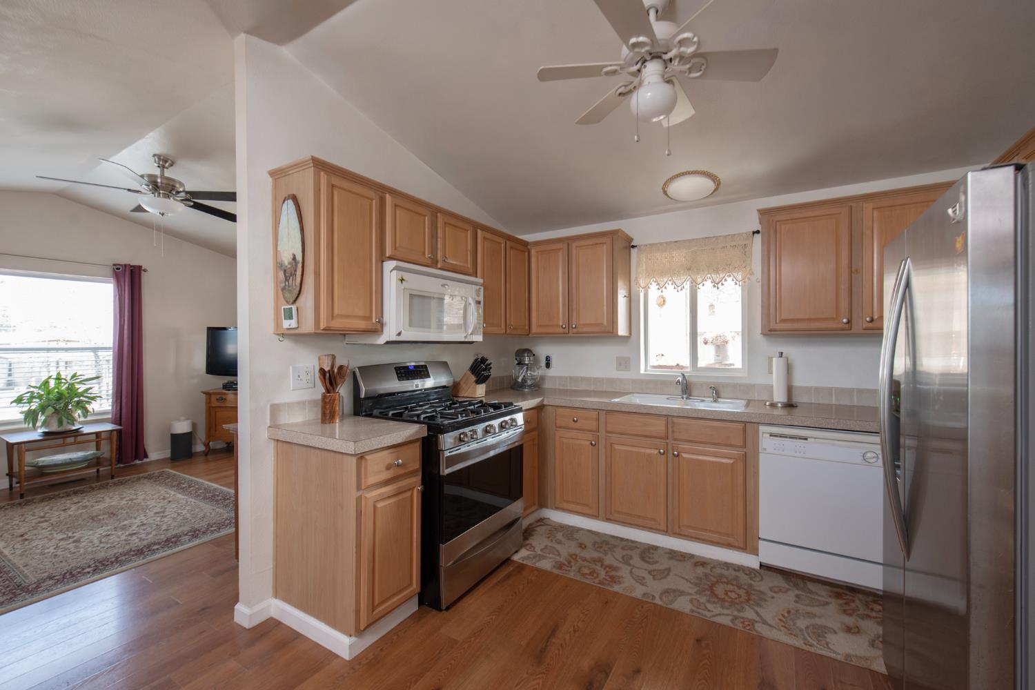 33751 Powerhouse Road, Unit 21 Auberry, CA 93602 - Photo 9 of 29 a kitchen with stainless steel appliances granite countertop a stove cabinets and entryway
