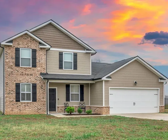 a front view of a house with garden