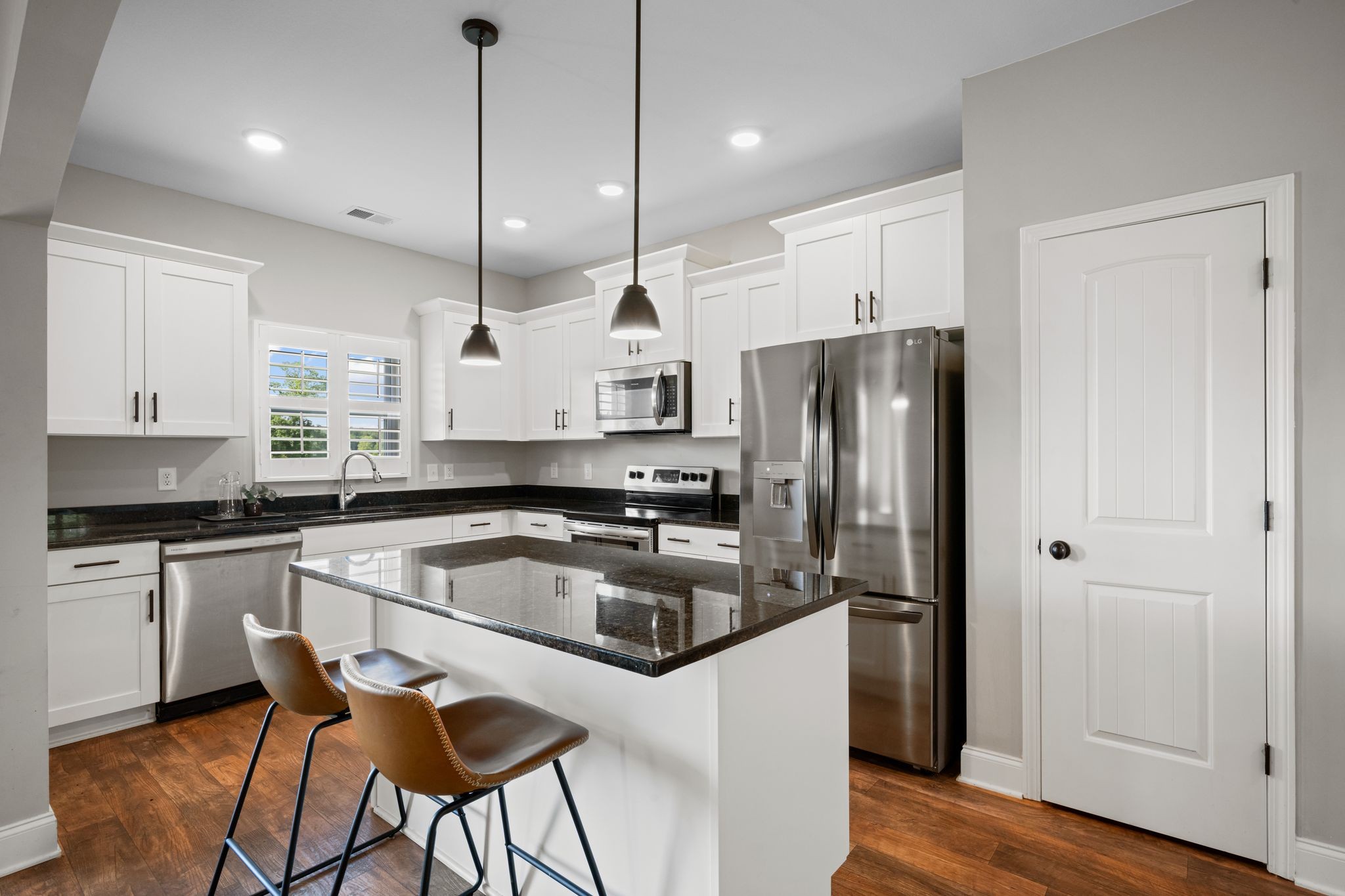 102 Murrell Road Dickson, TN 37055 - Photo 2 of 23 a kitchen with stainless steel appliances granite countertop a sink a stove a refrigerator and island with wooden floor