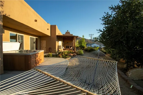 a view of a patio with dining table and chairs with wooden floor and fence