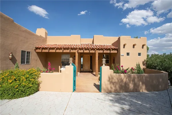 a front view of a house with a yard and entertaining space