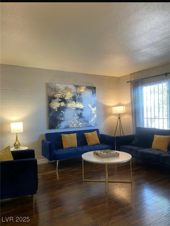 615 South Royal Crest Circle, Unit 8 Las Vegas, NV 89169 - Photo 4 of 11 Living area featuring a textured ceiling and wood