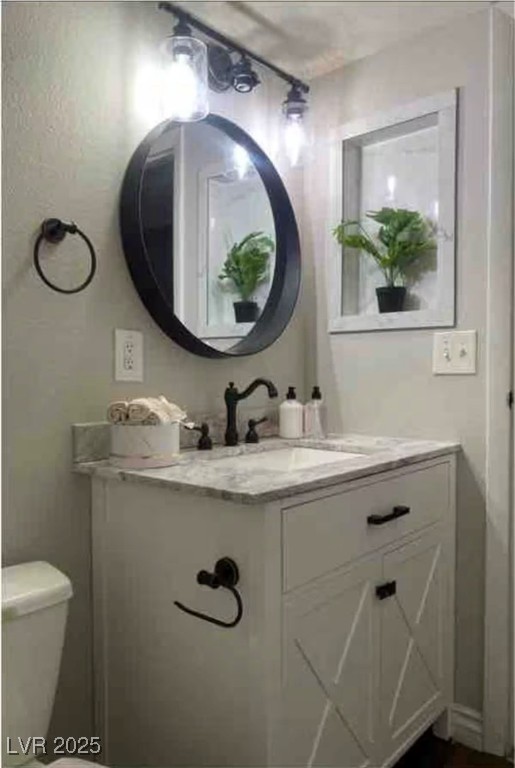 615 South Royal Crest Circle, Unit 8 Las Vegas, NV 89169 - Photo 10 of 11 Half bathroom featuring vanity and toilet