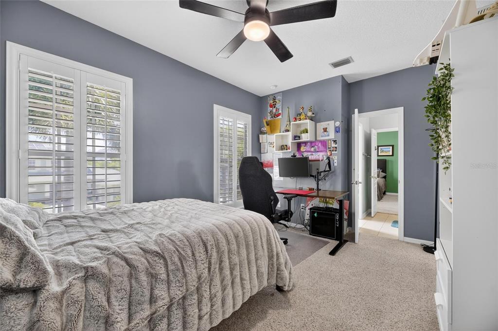 508 Islebay Drive Apollo Beach, FL 33572 - Photo 69 of 98 a bedroom that has a bed window and a ceiling fan