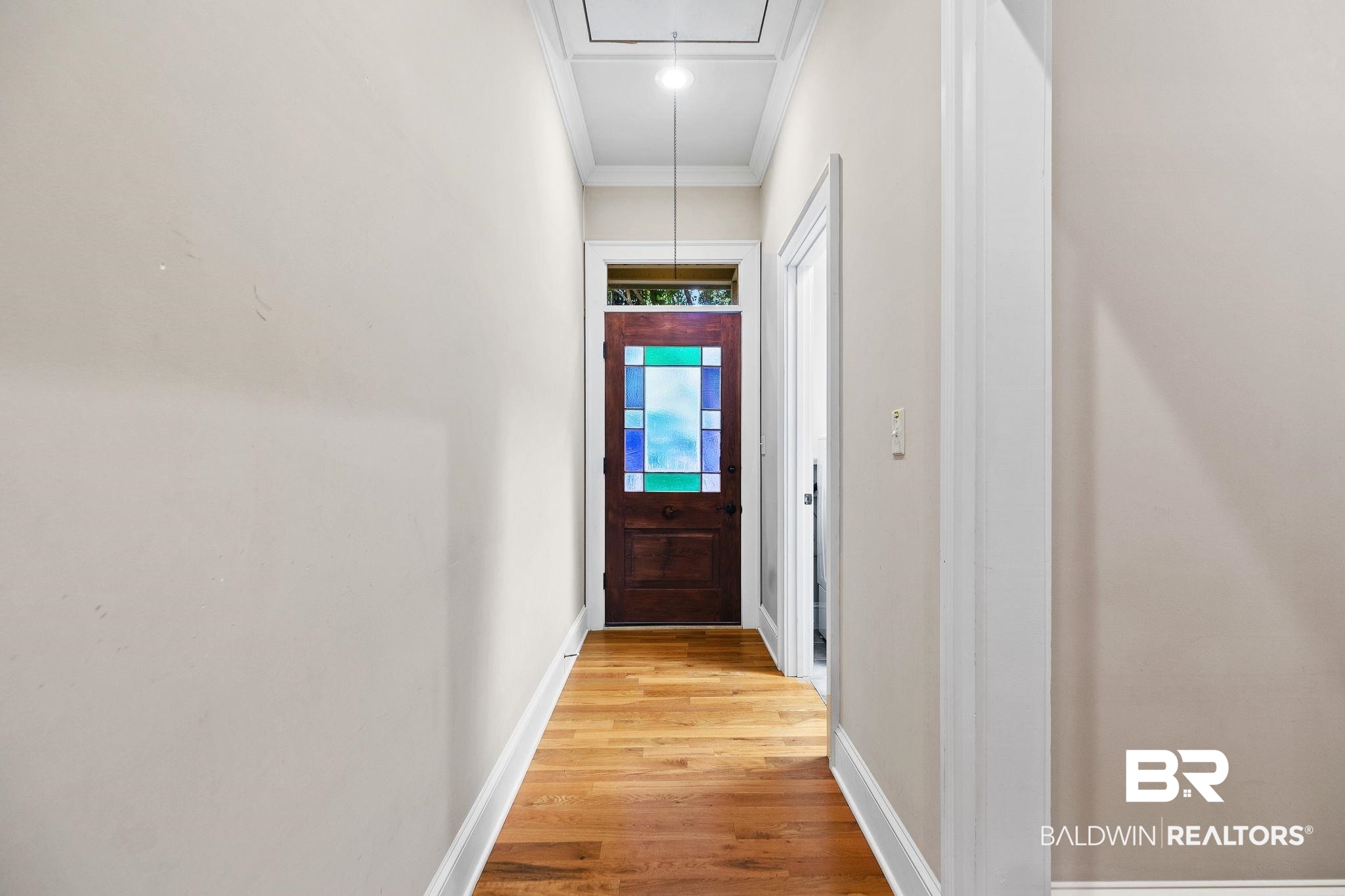 202 Beall Lane Daphne, AL 36526 - Photo 18 of 46 Doorway with crown molding and hardwood / wood-style floors