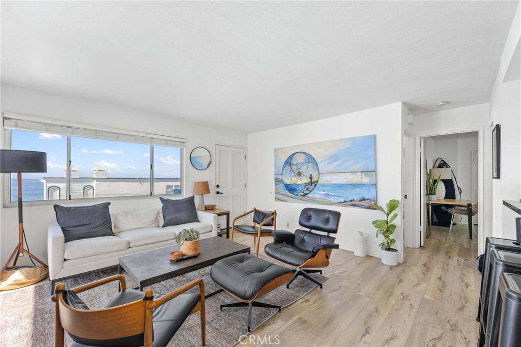 224 18th Street Manhattan Beach, CA 90266 - Photo 38 of 63 a living room with furniture a rug and white walls