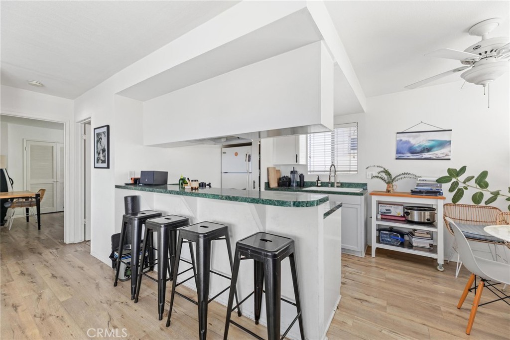 224 18th Street Manhattan Beach, CA 90266 - Photo 42 of 63 a kitchen with white cabinets and chairs