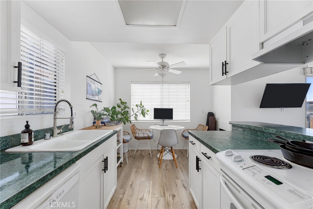 224 18th Street Manhattan Beach, CA 90266 - Photo 44 of 63 a kitchen with stainless steel appliances granite countertop a sink stove and refrigerator