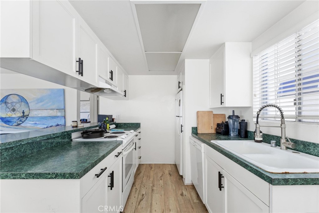 224 18th Street Manhattan Beach, CA 90266 - Photo 45 of 63 a kitchen with stainless steel appliances granite countertop a sink stove and cabinets