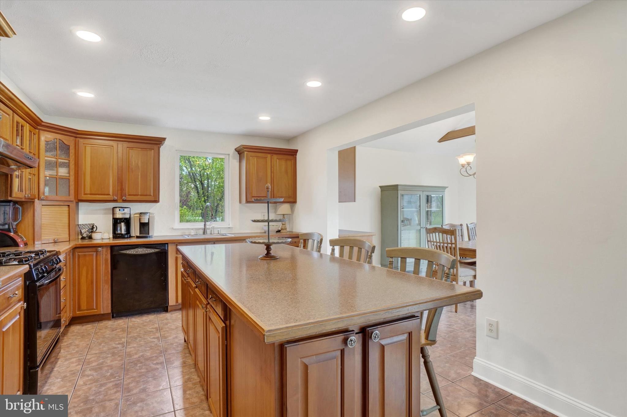 1190 Cherimoya Street York, PA 17404 - Photo 12 of 33 a kitchen with kitchen island a sink table and chairs
