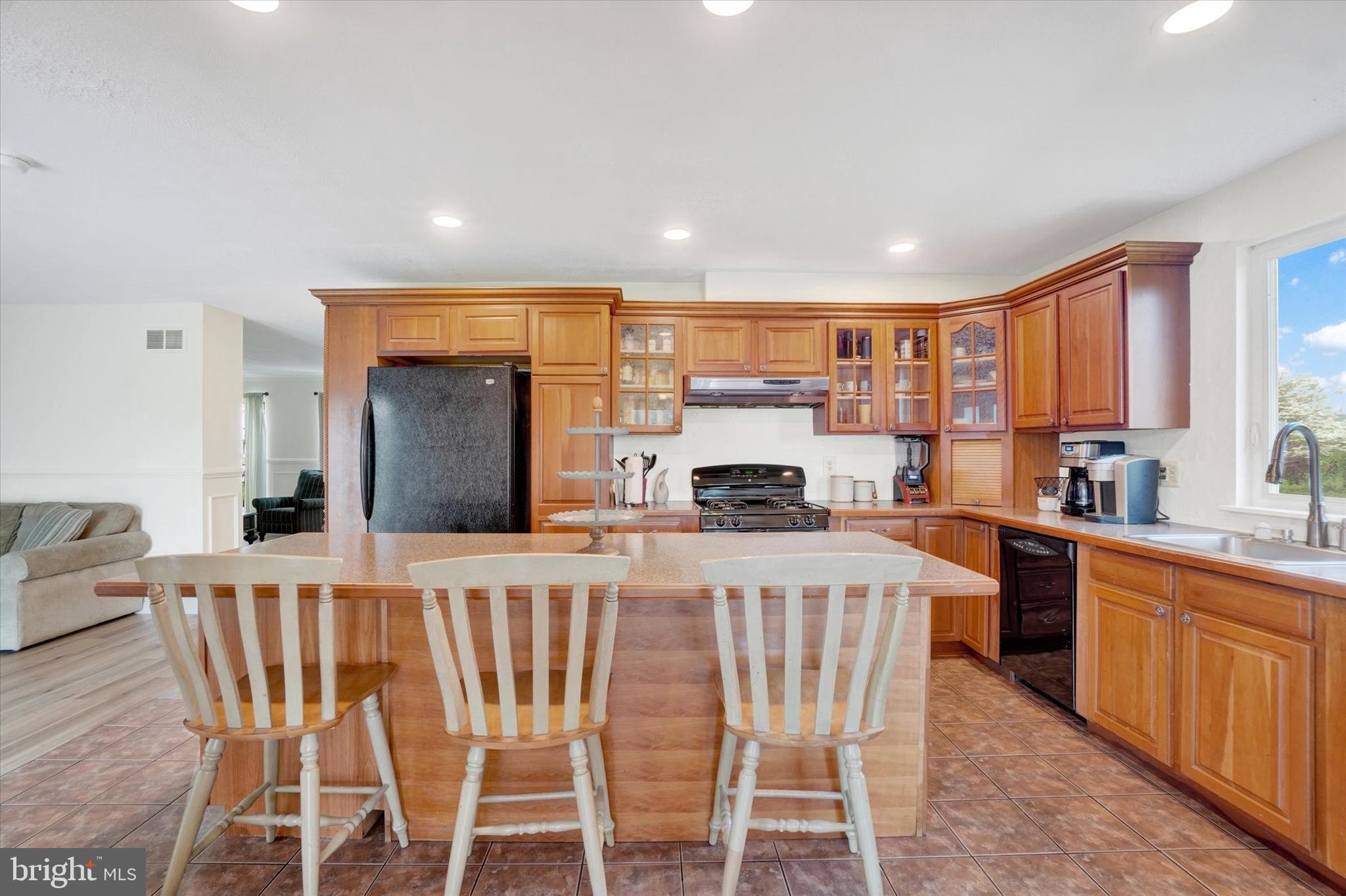 1190 Cherimoya Street York, PA 17404 - Photo 13 of 33 a kitchen with stainless steel appliances kitchen island granite countertop a sink and cabinets