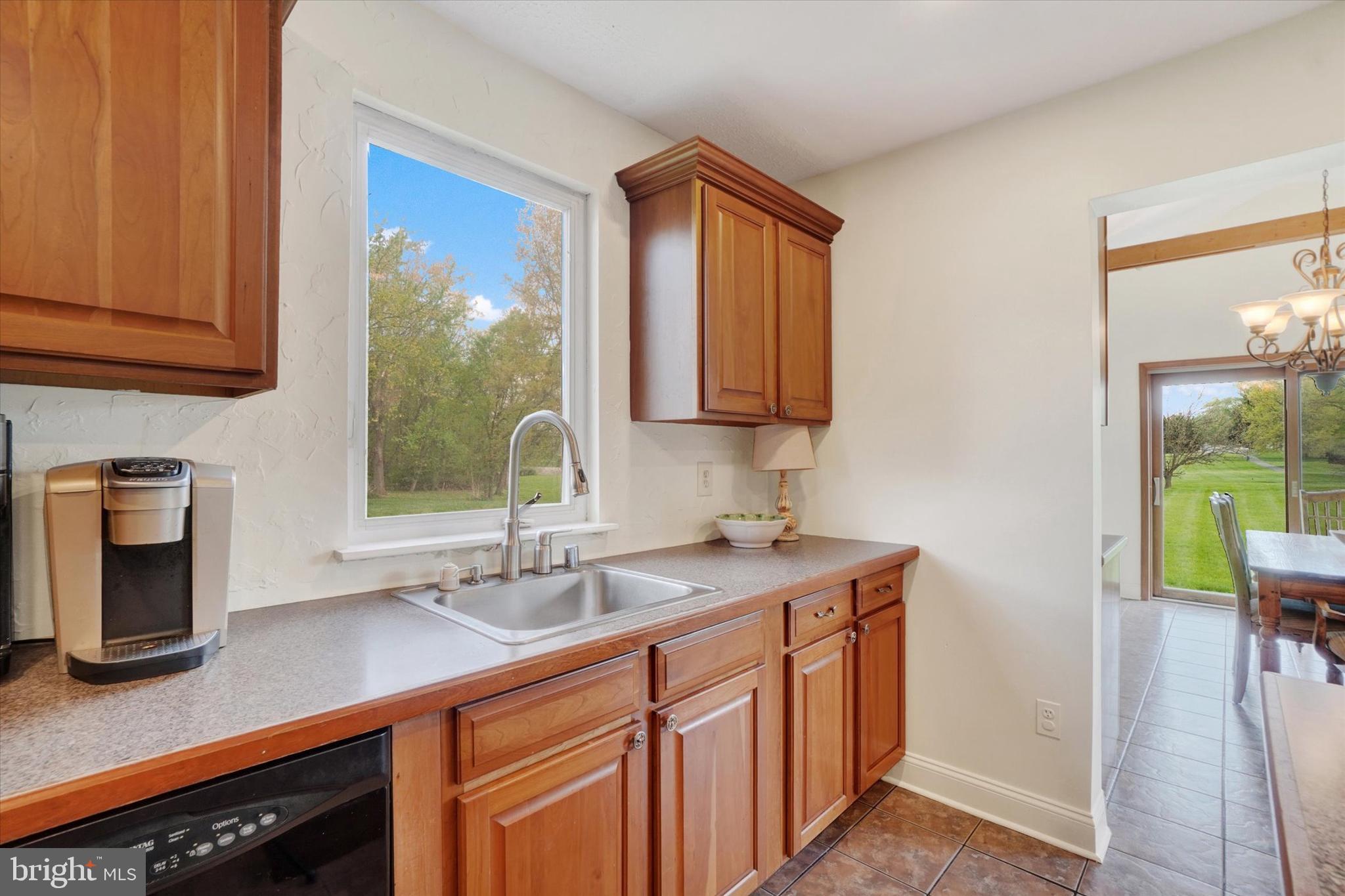 1190 Cherimoya Street York, PA 17404 - Photo 15 of 33 a kitchen with stainless steel appliances granite countertop a sink a stove and a wooden cabinets