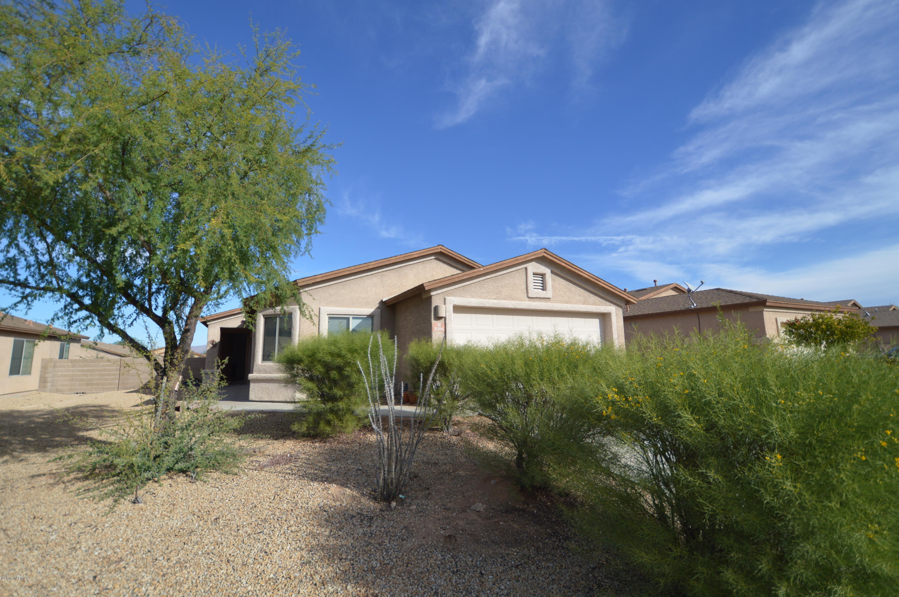 8396 West Benidorm Loop Tucson, AZ 85757 - Photo 2 of 13 a front view of a house with garden