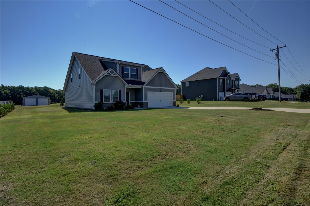 220 Clinkscales Road Anderson, SC 29624 - Photo 32 of 33 A spacious green lawn surrounds this contemporary multi-level home with an attached garage.