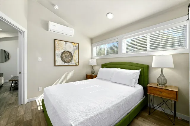 a bedroom with a bed and a window