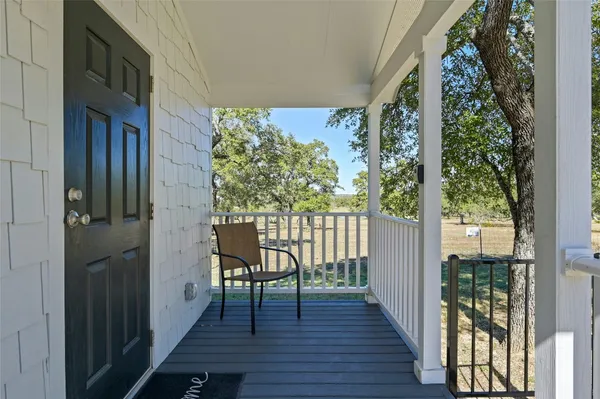 a view of a balcony with wooden floor and furniture
