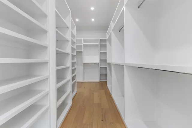 a view of walk in closet with empty racks