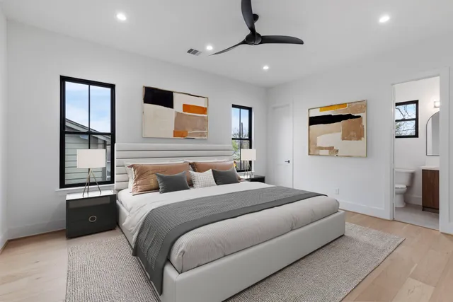 a bedroom with a bed and a painting