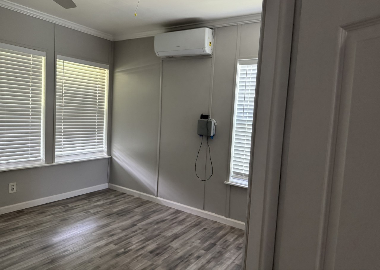 1813 Rhodes Road Austin, TX 78721 - Photo 10 of 14 A quiet space with sleek wood-look flooring and multiple windows awaits your personal touch.