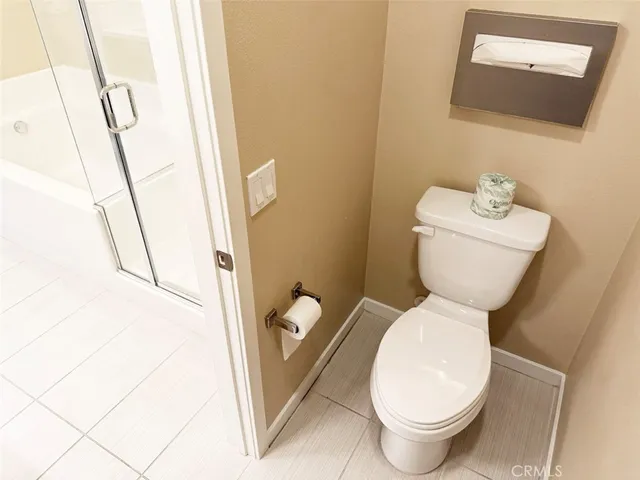 a bathroom with a toilet and a mirror