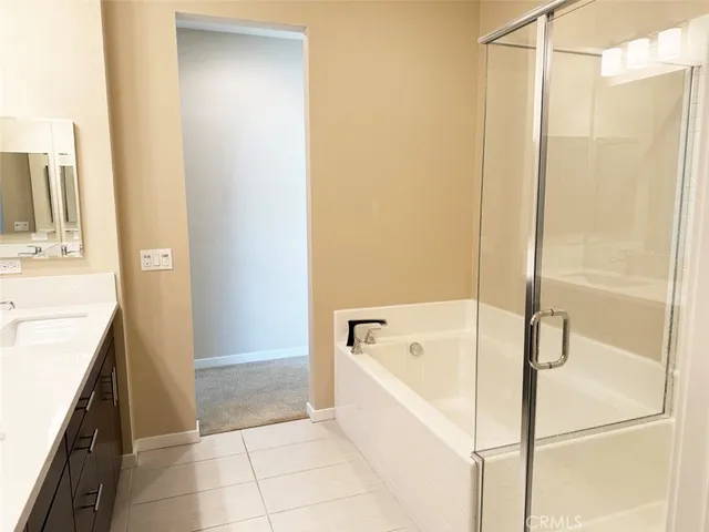 a bathroom with a tub shower and a sink