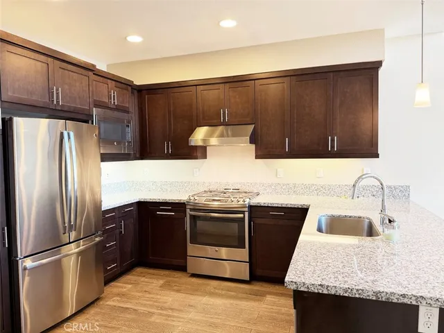 a kitchen with a sink and a refrigerator