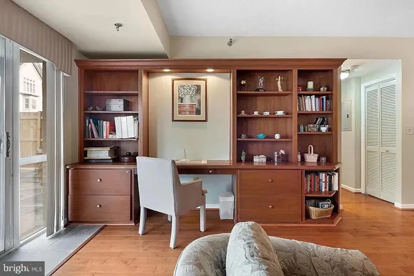 a living room with furniture wooden floor and a large window