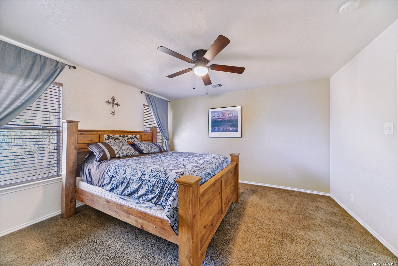 127 Hampton Bend Boerne, TX 78006 - Photo 16 of 25 a bedroom with a bed and a ceiling fan in it