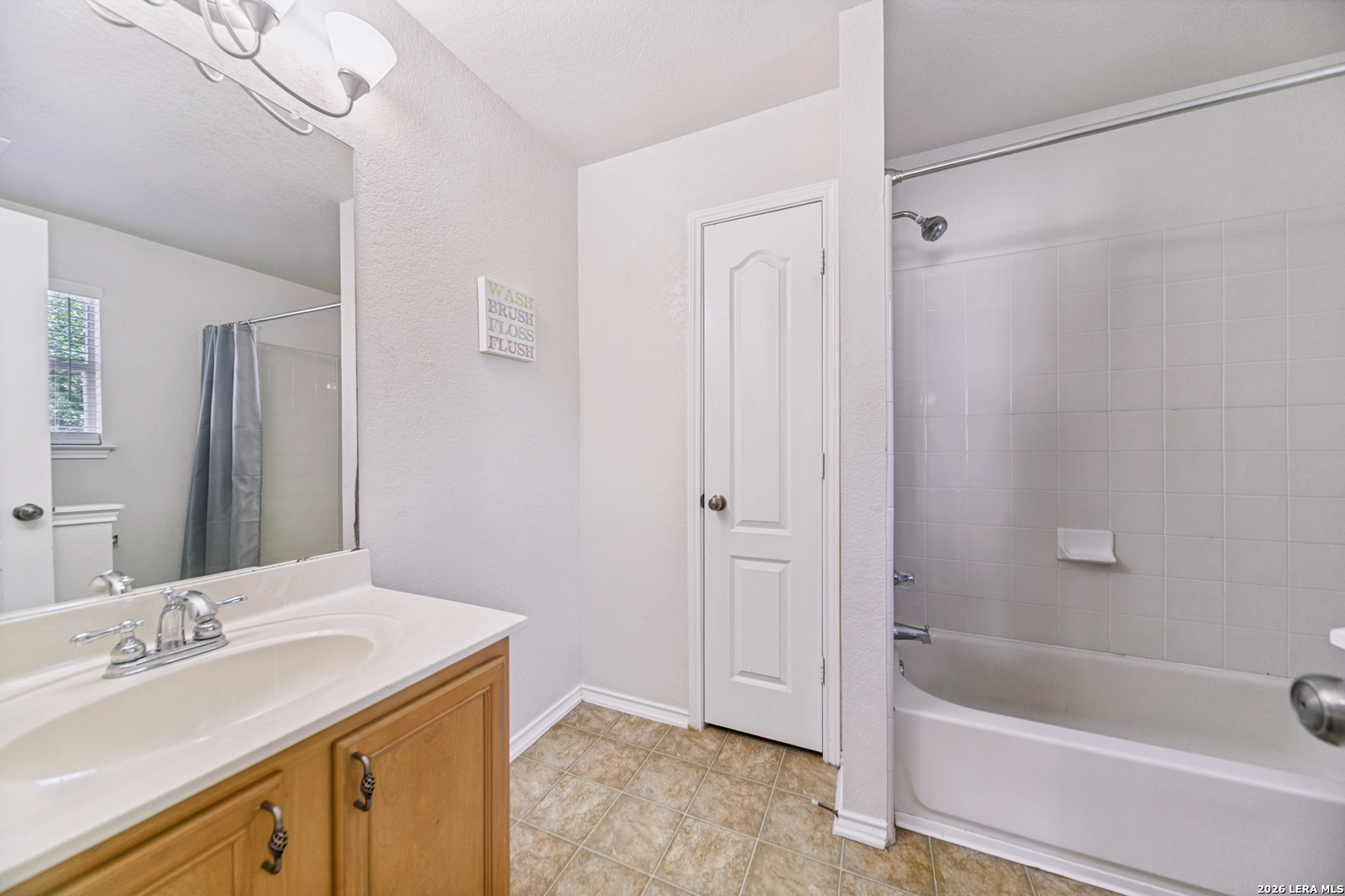 127 Hampton Bend Boerne, TX 78006 - Photo 18 of 25 a bathroom with a tub sink and mirror