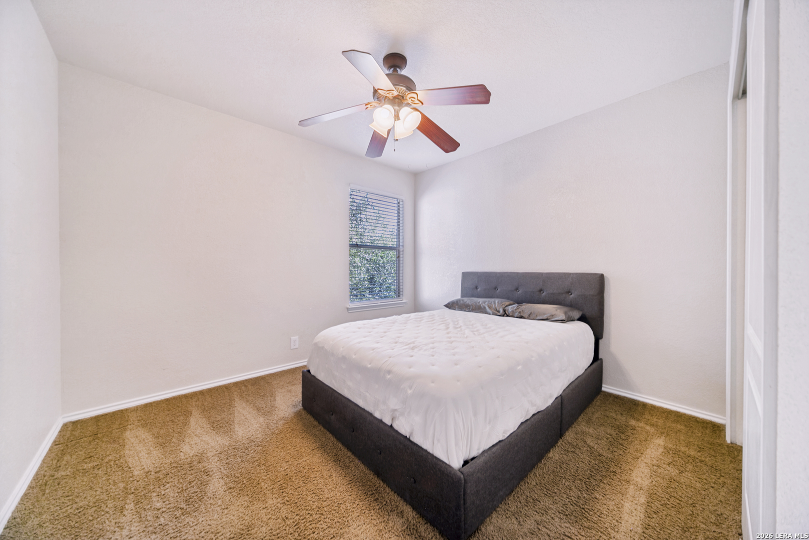 127 Hampton Bend Boerne, TX 78006 - Photo 20 of 25 a bedroom with a bed and a chandelier