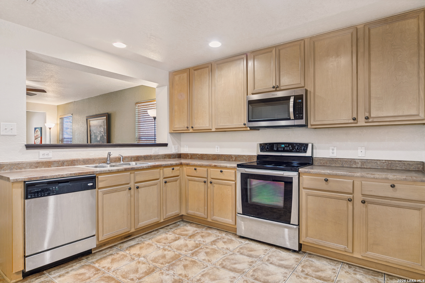 127 Hampton Bend Boerne, TX 78006 - Photo 10 of 25 a kitchen with granite countertop white cabinets stainless steel appliances and a sink