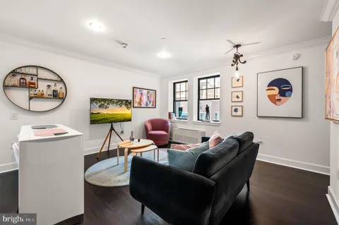 a living room with furniture and wooden floor