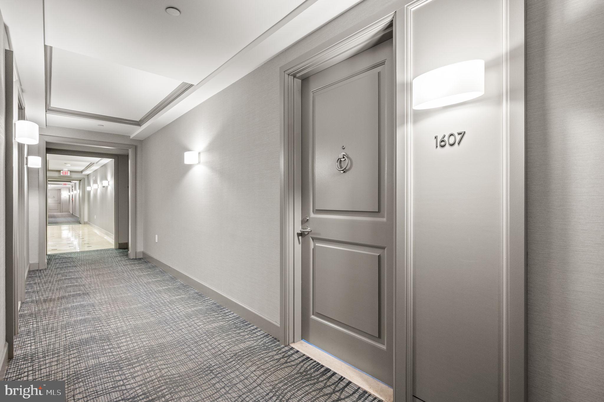1701 Locust Street, Unit 1607 Philadelphia, PA 19103 - Photo 14 of 26 a view of a hallway with wooden floor and a bathroom
