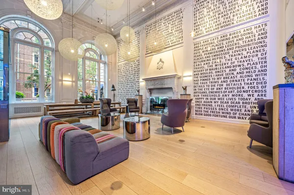 a living room with fireplace furniture and a floor to ceiling window