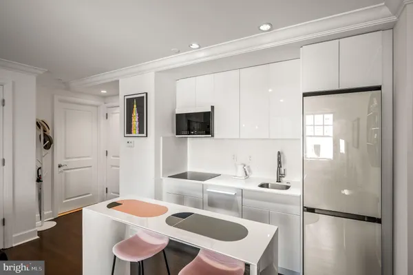 a kitchen with stainless steel appliances granite countertop a sink and a refrigerator