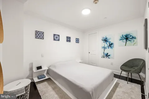 a bedroom with a bed and a chair