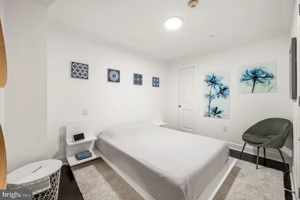 a bedroom with a bed and a chair