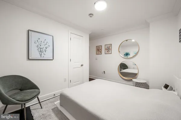 a bedroom with a bed and a chair