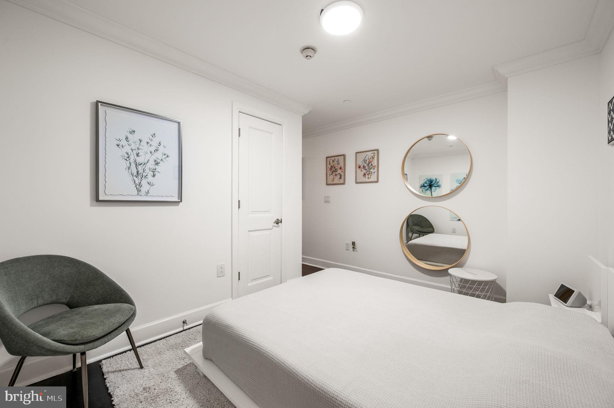 1701 Locust Street, Unit 1607 Philadelphia, PA 19103 - Photo 9 of 26 a bedroom with a bed and a chair